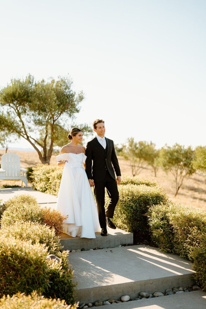 Newlywed couple walking down stairs